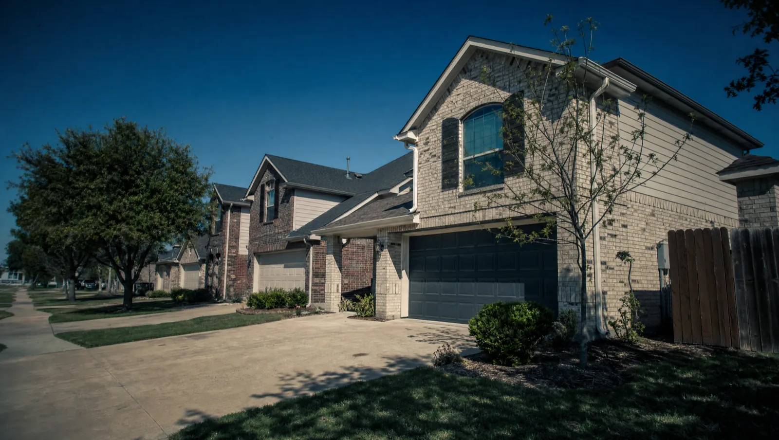 Brick family homes on a residential street in Hewitt, TX 76643, off the US-84 corridor