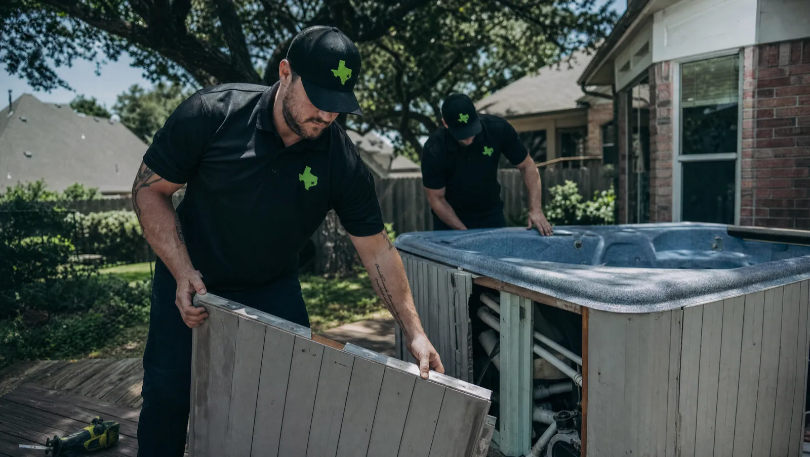 Sun-bleached hot tub being dismantled in a Waco, TX back garden for removal